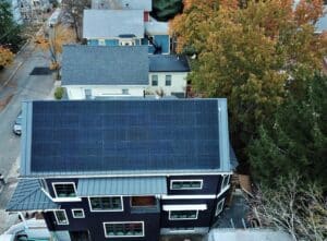 modern blue house with rooftop solar panels