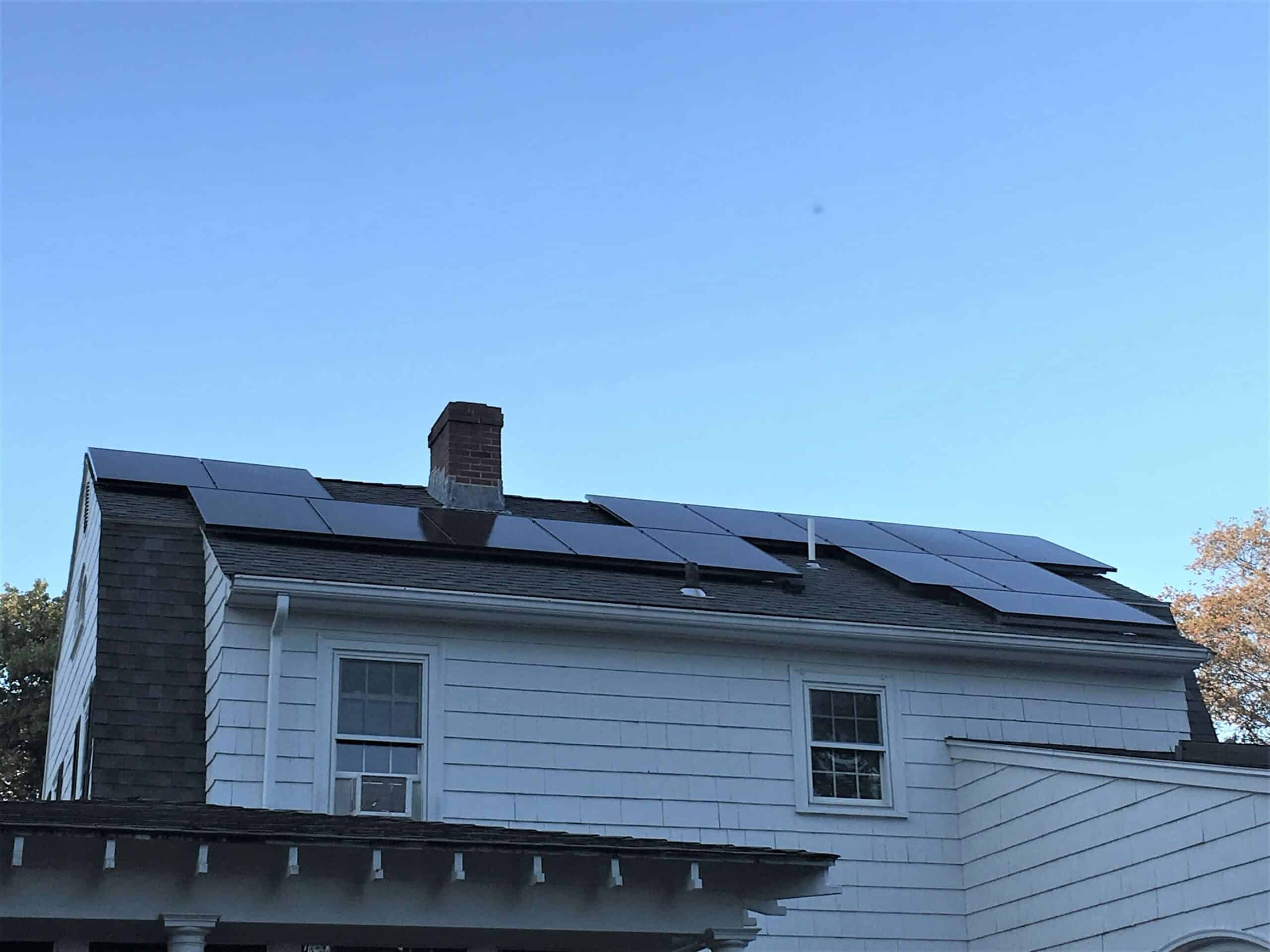 white house with all black rooftop solar panels